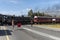 Man holding a red flag to hold traffic for a train to pass