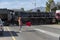 Man holding a red flag to hold traffic for a train to pass