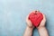 Man holding a red heart in hands top view. Healthy, love, donation organ, donor, hope and cardiology concept.