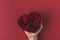 Man holding roses in heart shaped box on red tabletop, st valentines day concept