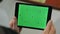 Man holding s tablet with chroma key screen. Man using tablet with green screen