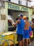 Man holding and showing a big fish in front of a fish market