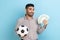 Man holding showing soccer ball and fun of hundred euro bills winning lot of money betting for sport