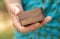 Man holding a small simple generic wooden box container in hand, detail, closeup, mystery gift box, presents and gifts. Box for