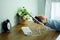 Man is holding smartphone is charging with backup Power bank on the desk wooden table