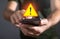 Man holding smartphone. System hacked warning alert