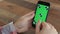 Man Holding Smartphone Touch Screen With Green Screen Chroma Key For Custom Content