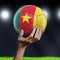 Man holding Soccer ball with Cameroon flag
