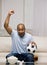 Man holding soccer ball cheering