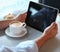 Man holding tablet computer in cafe