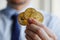 Man holding three Bitcoin coins in hand