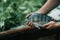 Man holding a Tilapia fish, green blur background