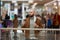 A man is holding a took-off mask while drinking coffee in the shopping center