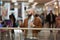 A man is holding a took-off mask while drinking coffee in the shopping center