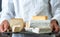 Man holding a tray with various french cheeses