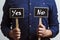 man holding two chalkboards with yes and no answers - YES and NO - Evaluation and decision making concept