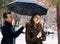 man holding an umbrella over the attractive girl