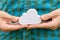 Man holding up a small white cloud object symbol in his hands, closeup. Cloud server computing, distributed processing power and