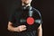 Man holding vinyl record over heart. Music passion. Vintage music style. Male with headphones holding old vinyl disk standing on