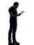 Man holding watching digital tablet silhouette