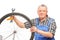 Man holding wrench and repairing bicycle wheel