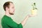 Man holding yellow flowerpot with Kalanchoe plant