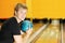 Man holds ball and prepares to throw in bowling