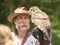 Man holds barred owl during falconry demonstration