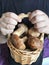 A man holds with both hands a basket full of porcini mushrooms