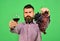 Man holds bunch of grapes and glass of wine