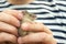 Man holds a caught field mouse in his hands. little scared rodent in the hands