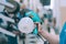 A man holds an electric spray gun in his hand. A buyer in a hardware store selects a product