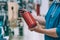 A man holds a fire extinguisher in his hand. A buyer in a hardware store selects a product