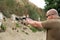 a man holds a gun in his hands. pistol shooting exercises