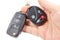 Man holds in hand ignition key and garage door remote control
