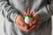 man holds in hands easter egg decorated as a cute unicorn