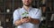Man holds in hands sprout of green plant in soil