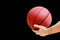 Man holds in his hand a basketball game ball