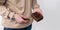 Man holds in his hand a cigarette case made of brown craft leather