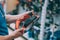 A man holds in his hand an electric planer for a tree. A buyer in a hardware store selects a product
