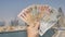 A man holds in his hand the money of the Arab Emirates. Hand close-up.