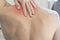 Man holds his hand for redness in shoulder and neck. Man have neck pain, shoulder pain