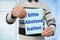 Man holds in his hand a sheet of paper with the inscription in German keep your distance, concept of news and urgent messages