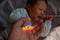 A man holds his newborn son's hand. Beam of light through a prism.