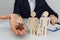 Man holds a house keys. Wooden figures of a family ahead. Mortgage and purchase house concept