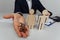 Man holds a house keys. Wooden figures is near with his hand. Mortgage concept