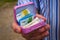 A Man Holds A Miniature Pink Suitcase With Chocolate And Real Euro Notes The Common Currency Of The European Union