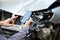 Man holds mockup mobile phone screen in hands after car accident. Calling insurance service in web app to place of car accident.