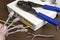 A man holds a network cable in his hand, a modem on the desk, a close-up, router