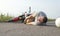 A man holds onto his knee, lying on the asphalt near the motorcycle, the theme of road accidents